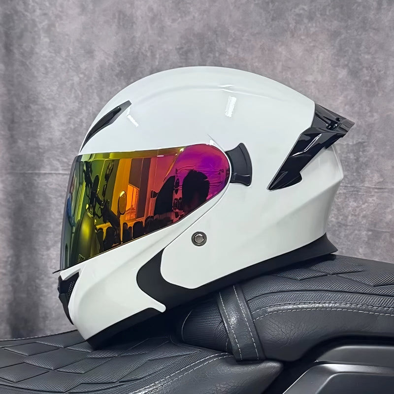 White motorcycle helmet with a colorful visor on a black seat against a gray background