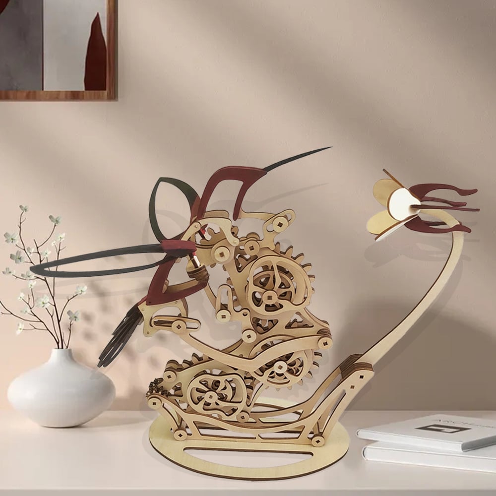 Wooden mechanical model of a dragon on a shelf with a vase and notebook iPuzzloria | Kinetic Hummingbird Sculpture - 3D Wooden Mechanical Puzzle Kit