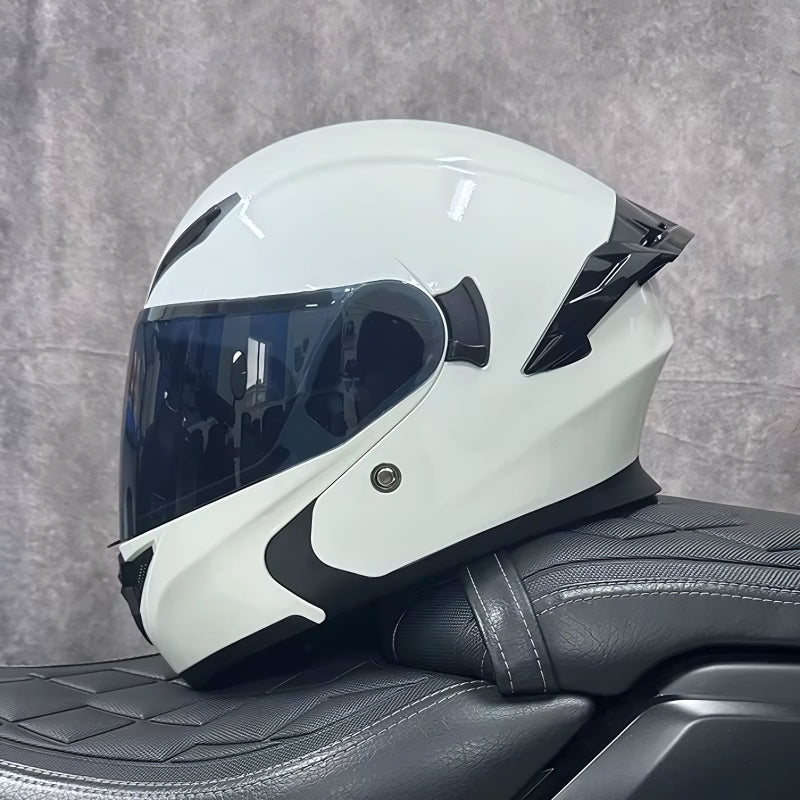 White motorcycle helmet with a black visor on a gray textured background