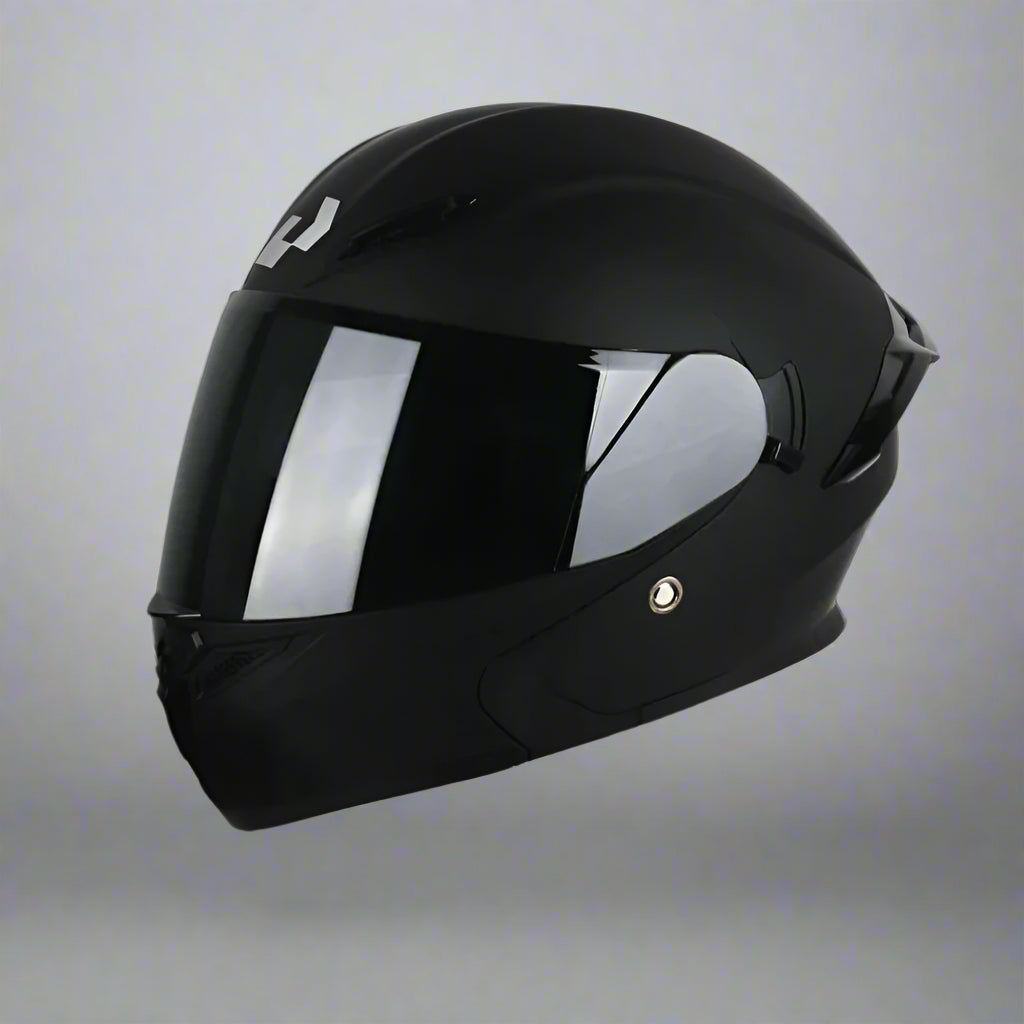 Black full helmet with double lens design on a white platform against a dark background