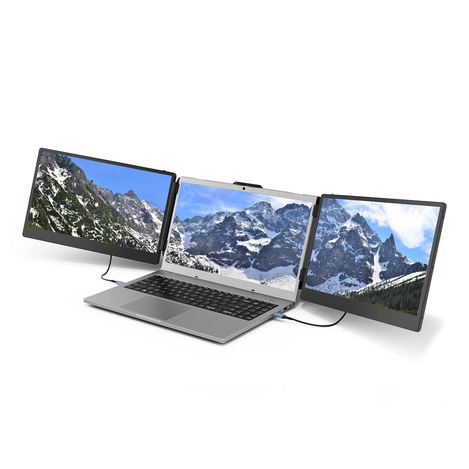 Laptop with two external monitors displaying mountain scenery on a white background