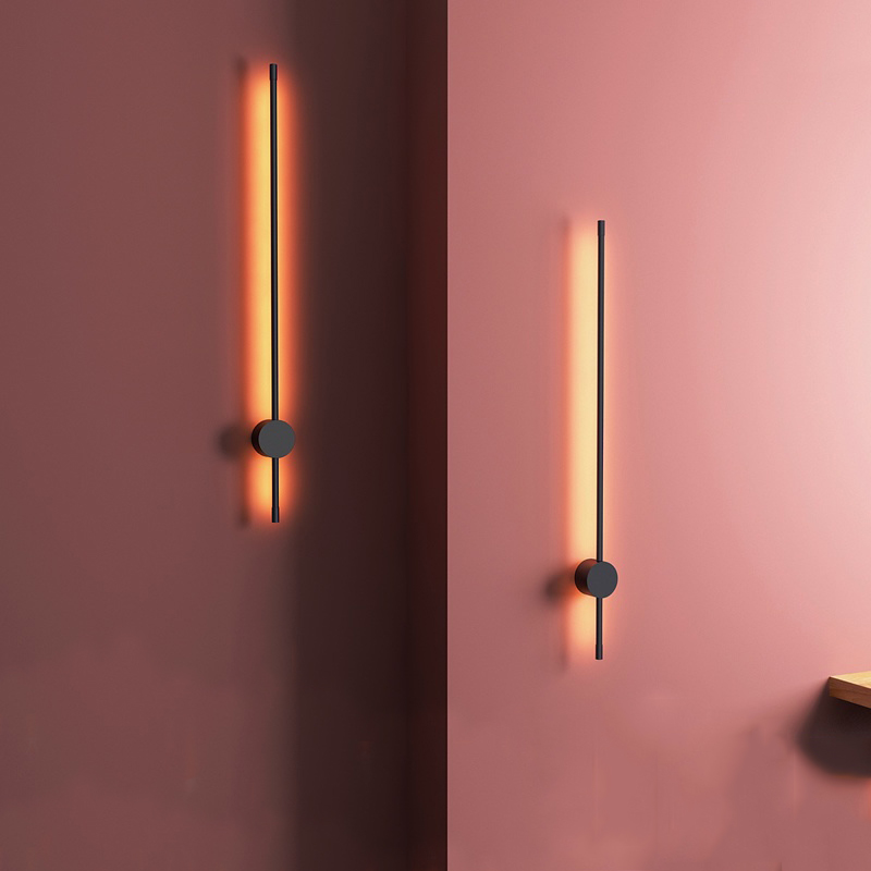 Two modern wall lights on a pink wall
