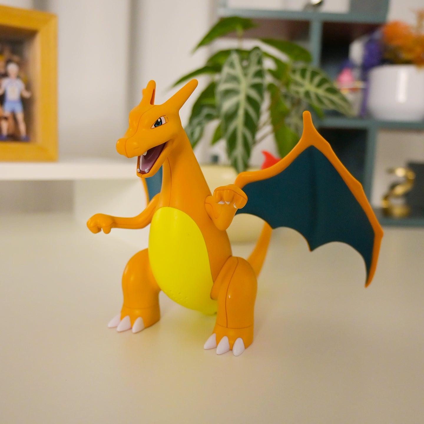 Toy Charizard figure on a surface with a blurred indoor background