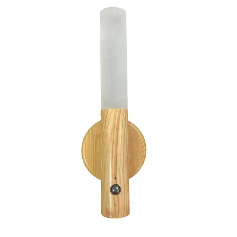 Wooden wall sconce with a cylindrical white shade on a white background