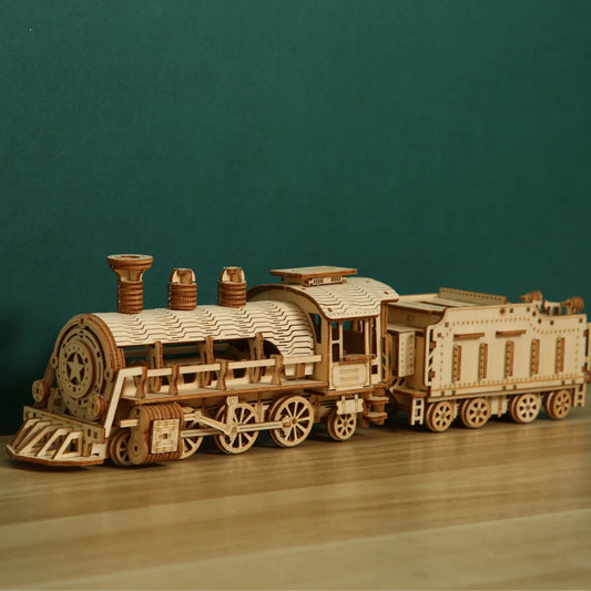 3D wooden steam locomotive puzzle kit on green display showing detailed birch construction adult model decor