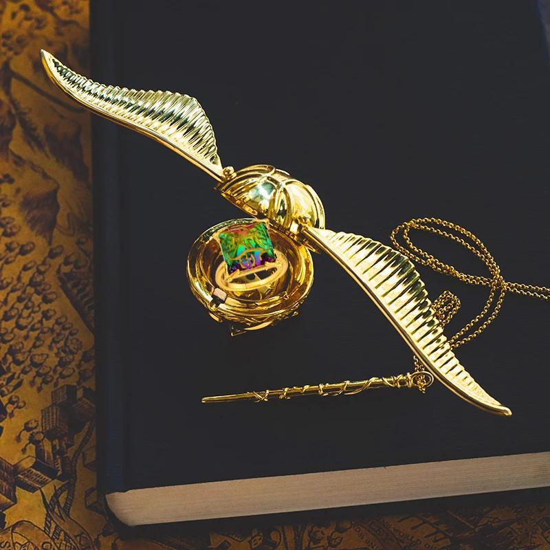 Golden snitch ring box with wings open showing the velvet ring insert, Harry Potter inspired proposal box