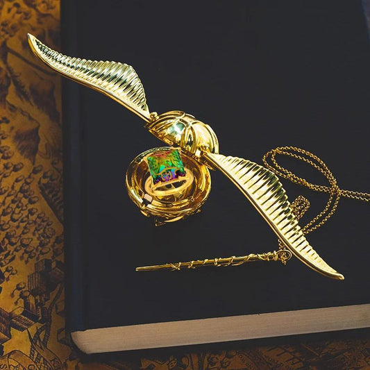 Golden snitch ring box with wings open showing the velvet ring insert, Harry Potter inspired proposal box
