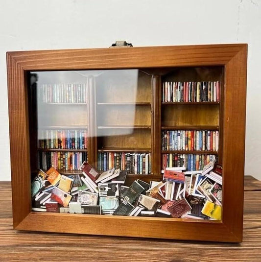 Puzzloria Original Anxiety Bookshelf wooden frame with 260 colorful miniature books behind a glass-front