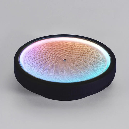 kinetic sand art table with color-changing RGB LED light drawing geometric patterns in white sand