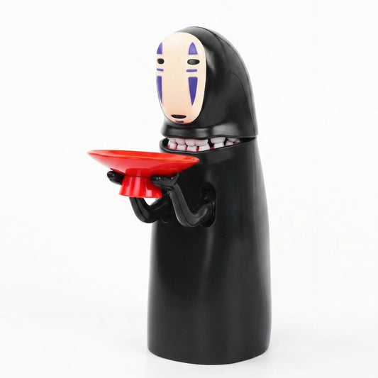 No face coin bank with a red coin tray in its hands, a Kaonashi inspired automatic money box from Puzzloria