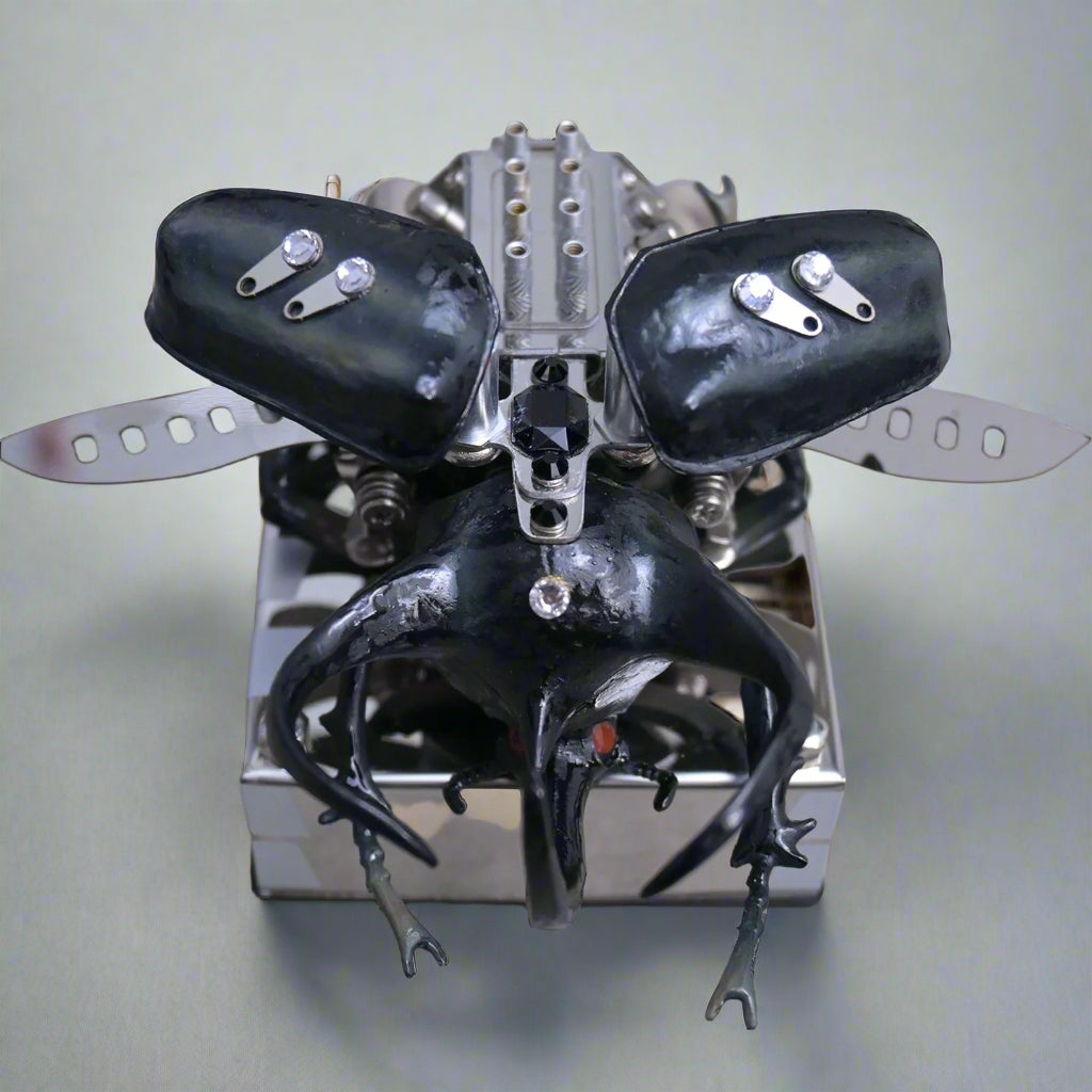 Metallic insect-like creature with black wings and legs on a reflective surface
Puzzloria mechanical model kit DIY assembly engineering educational toy