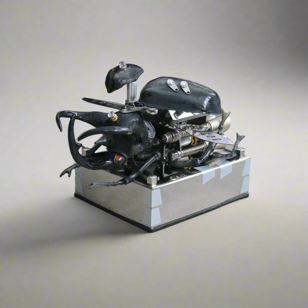 Toy beetle with mechanical components on a reflective surface, Puzzloria mechanical model kit DIY assembly engineering educational toy