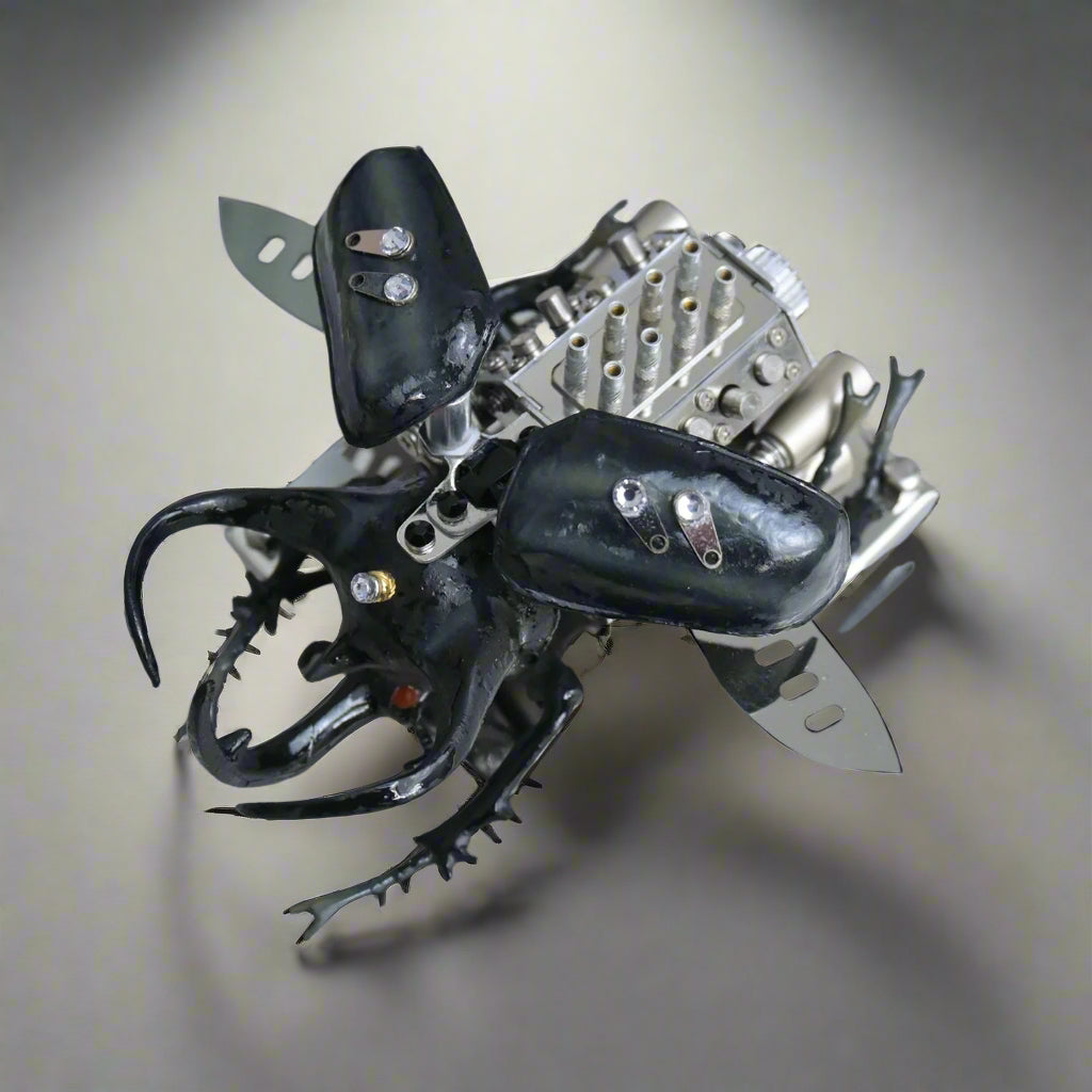 Metallic beetle toy with black and silver details on a white background, Puzzloria mechanical model kit DIY assembly engineering educational toy