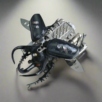 Metallic beetle toy with black and silver details on a white background, Puzzloria mechanical model kit DIY assembly engineering educational toy