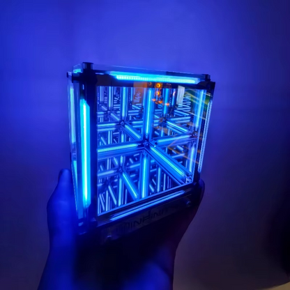 Hand holding a transparent cube with blue internal lighting against a dark background