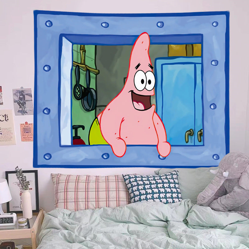 Cartoon character wall tapestry hanging above a bed with pillows and a lamp.