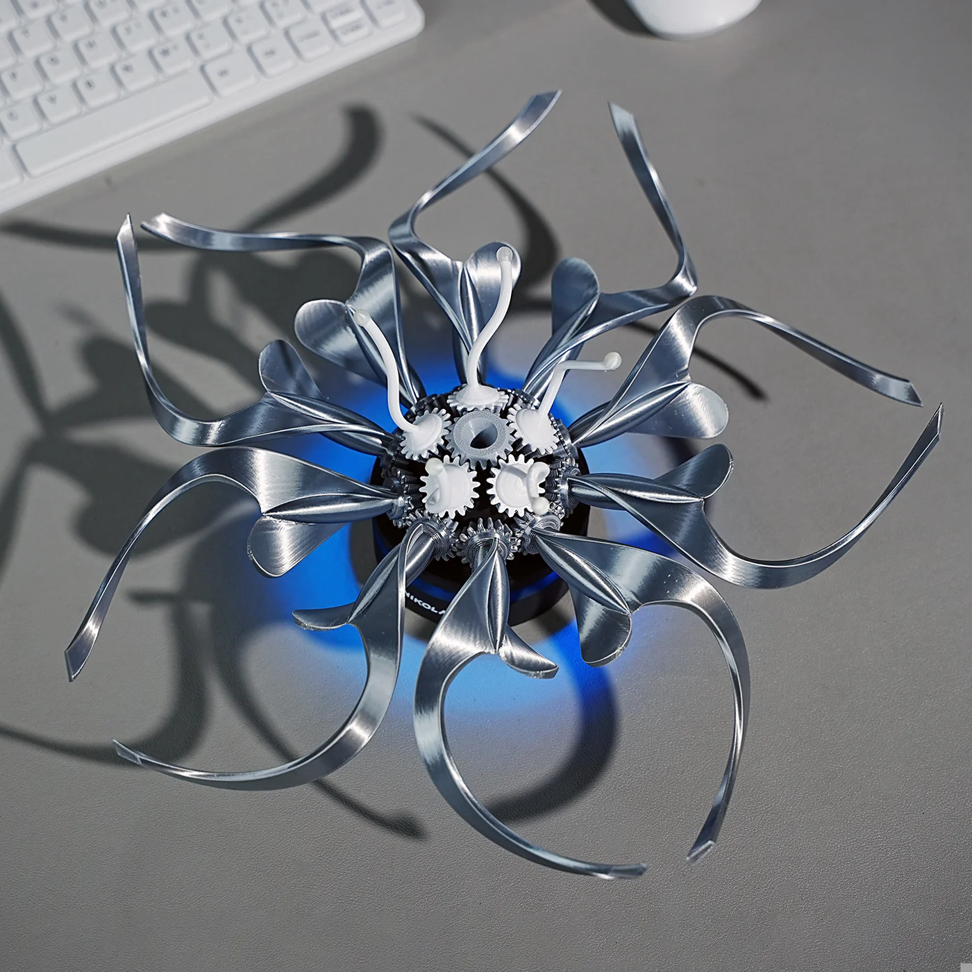 Puzzloria metal flower sculpture with mechanical gears and curved steel petals for steampunk desk decor