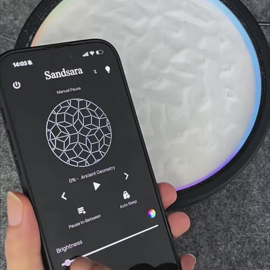 kinetic sand art table in motion drawing zen sand patterns with color-changing LED light, mesmerizing app-controlled desk decor and gift