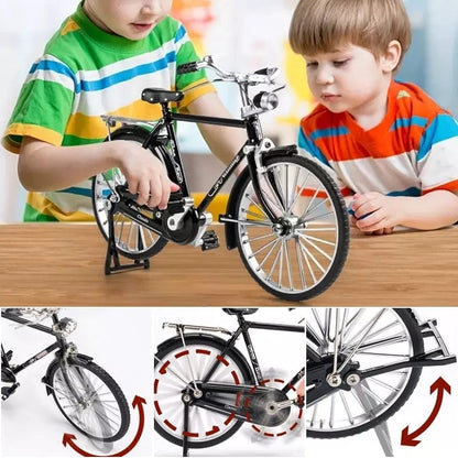 Two children playing with a toy bicycle on a wooden table, with close-up details of the bike shown below.