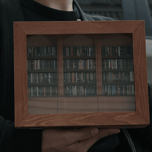 anxiety bookshelf held in hands showing scale mini library with 260 tiny books wellness desk accessory thoughtful gift