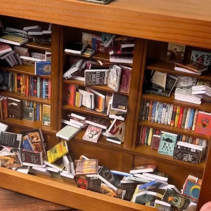 miniature books close up showing printed spines real book titles inside the anxiety bookshelf for bookworm desk decor