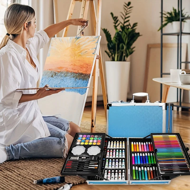 145 piece art set lifestyle shot woman painting at easel with aluminum drawing and painting kit – Blue, Pink, Astronaut