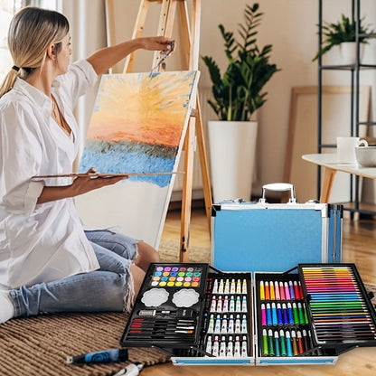 145 piece art set lifestyle shot woman painting at easel with aluminum drawing and painting kit – Blue, Pink, Astronaut