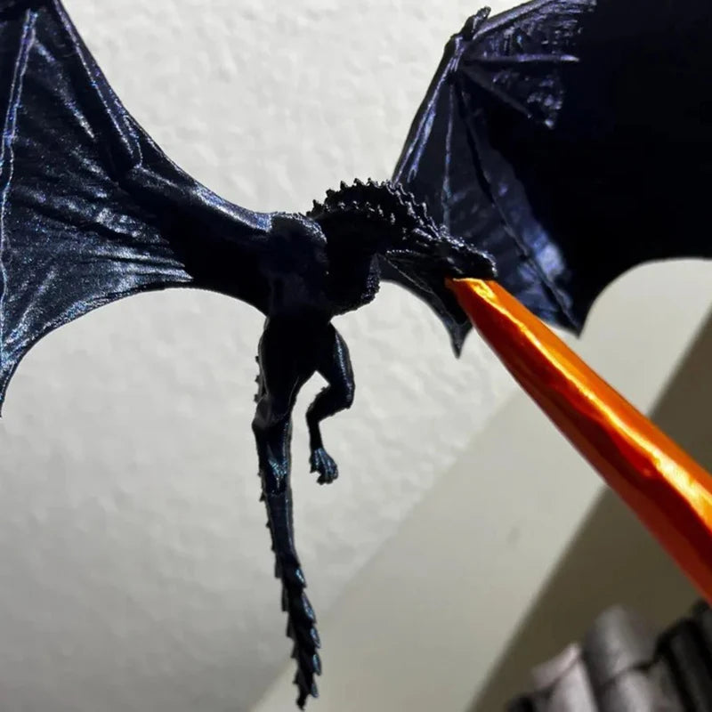 black dragon sculpture with veined wings and a spiked tail perched above the shelf, gothic fantasy decor ornament