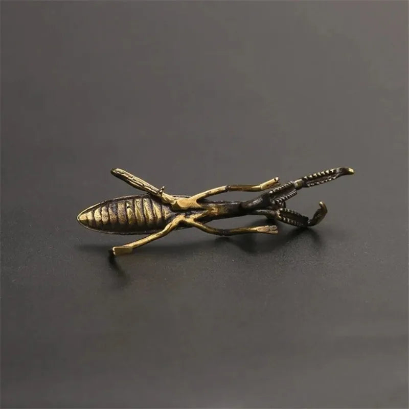 detailed underside of a solid brass insect figurine, cast metal tea pet that patinas with use over time