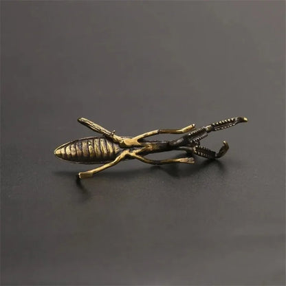 detailed underside of a solid brass insect figurine, cast metal tea pet that patinas with use over time