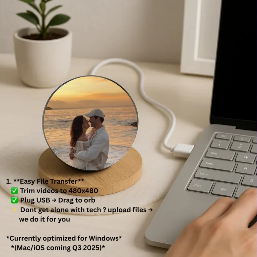 Laptop with a circular photo display showing a couple at sunset, connected to a wooden device with USB cable.