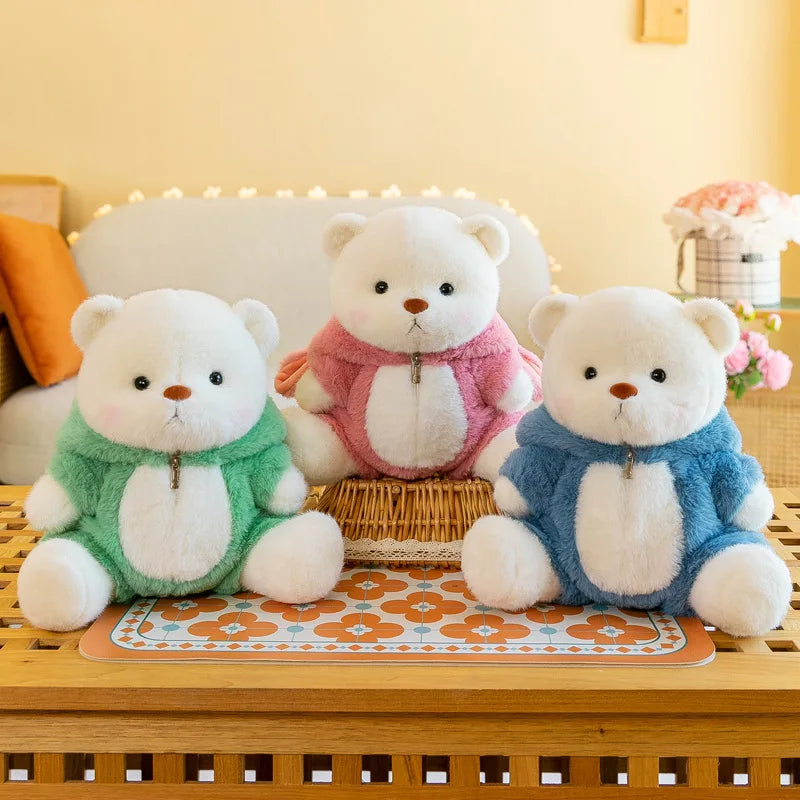 Three teddy bears in colorful outfits sitting on a wooden surface with a soft, blurred background.