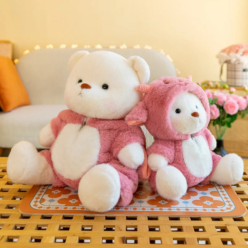 Two teddy bears in pink outfits sitting on a decorative mat with a blurred background