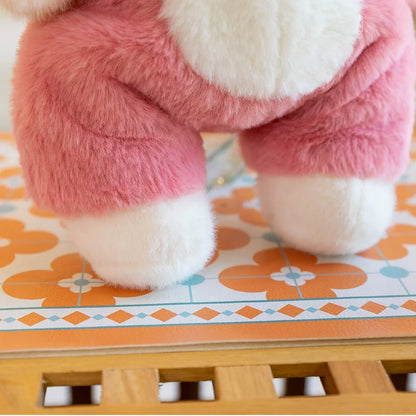 Close-up of a pink plush toy on a colorful tile floor