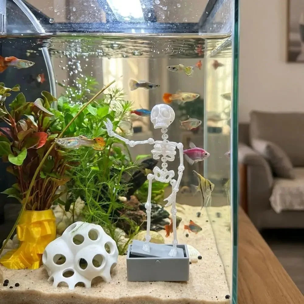 underwater skeleton decor swaying among aquarium plants and guppies as an air driven fish tank centerpiece