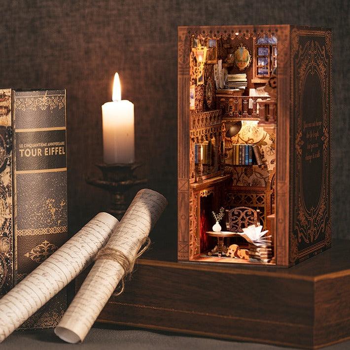eternal bookstore book nook kit assembled and lit beside candles as a miniature library shelf insert, Eternal Bookstore
