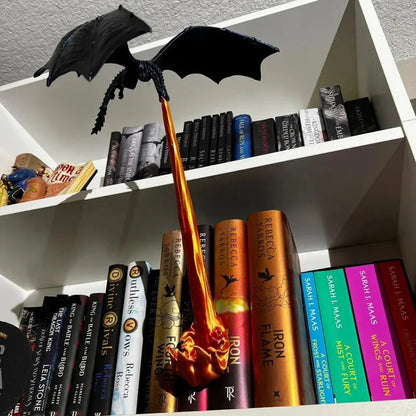 dragon bookshelf decor staged on a fantasy book shelf with fire pouring between novels in a romantasy home library