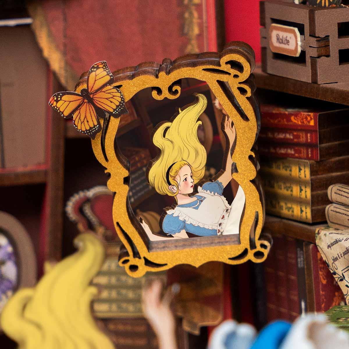 alice in a gilded frame with a butterfly, hand painted wonderland detail inside a miniature diorama kit