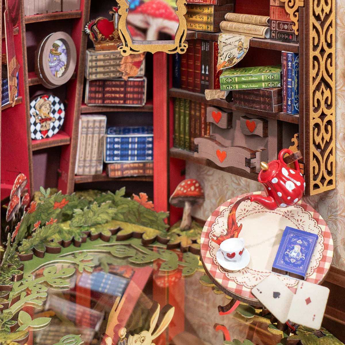 miniature library interior with tiny books playing cards and red heart motifs inside a wonderland bookshelf insert