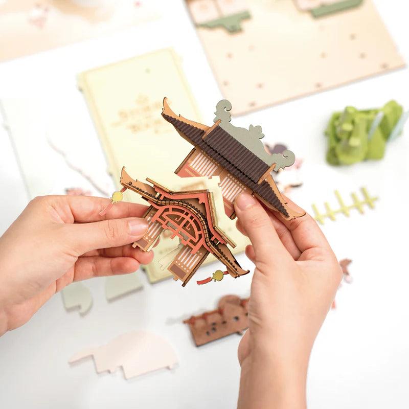 laser cut wooden pagoda parts being assembled by hand beginner friendly craft kit project for adults and teens