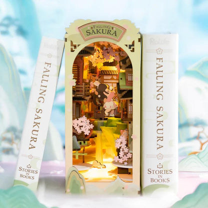 book nook cherry blossom diorama slotted between novels on a shelf as japanese style reading corner decor