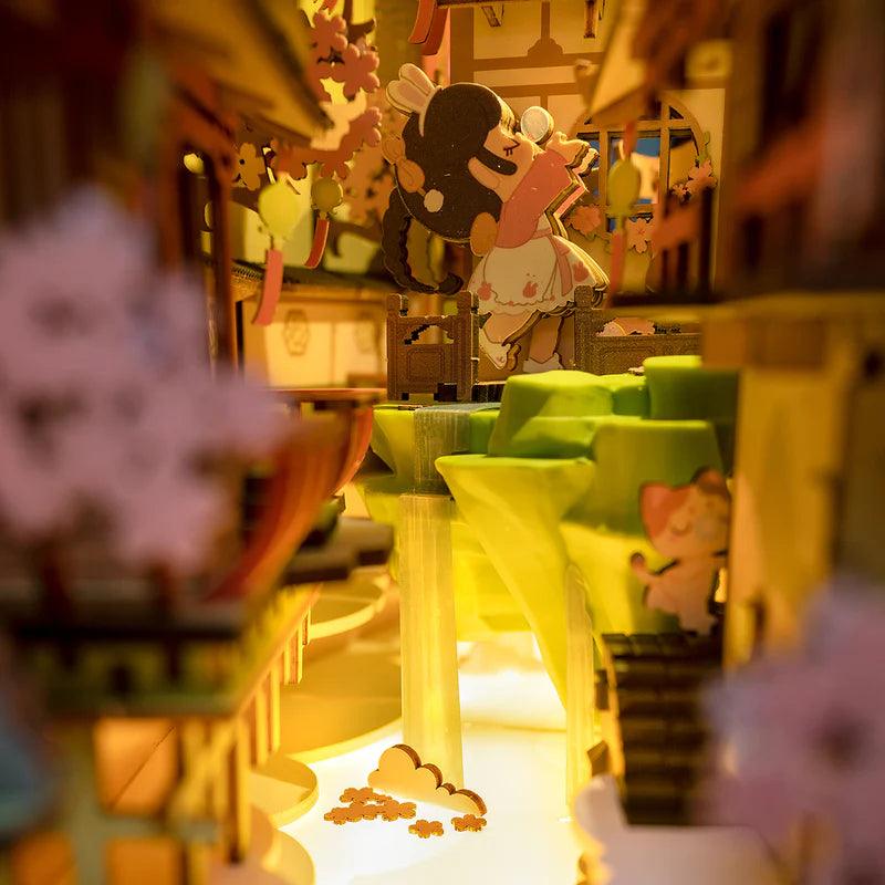 miniature japanese street interior with led lit river lanterns and wooden shopfronts inside a book nook kit