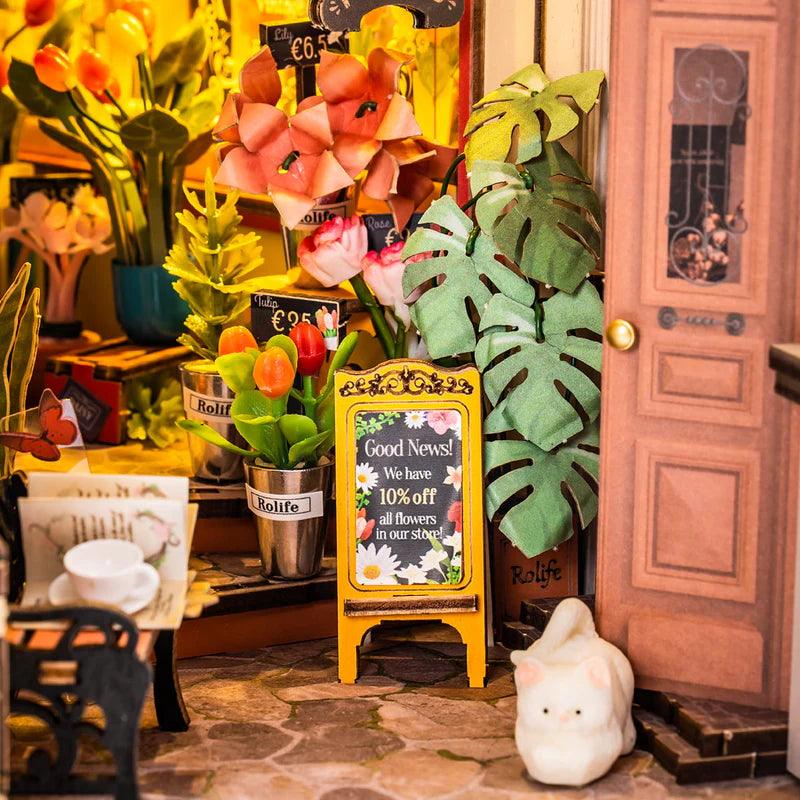 diy book nook shelf insert florist corner miniature diorama with warm LED lighting for a bookcase craft gift idea
