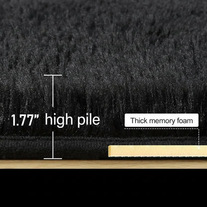 Close-up of black hair with text indicating 1.77" high pile and thick memory foam, with a wooden stick for scale.