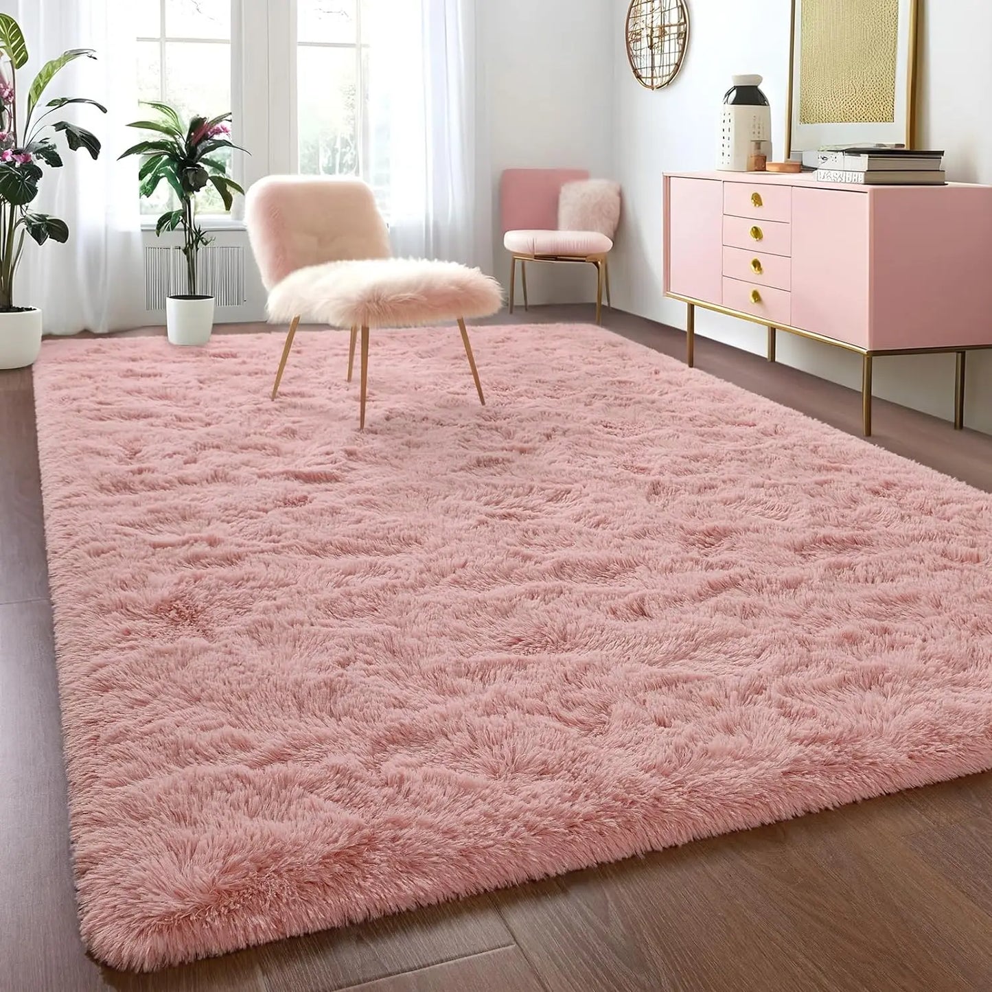Pink shaggy rug in a room with pink chairs and a cabinet.