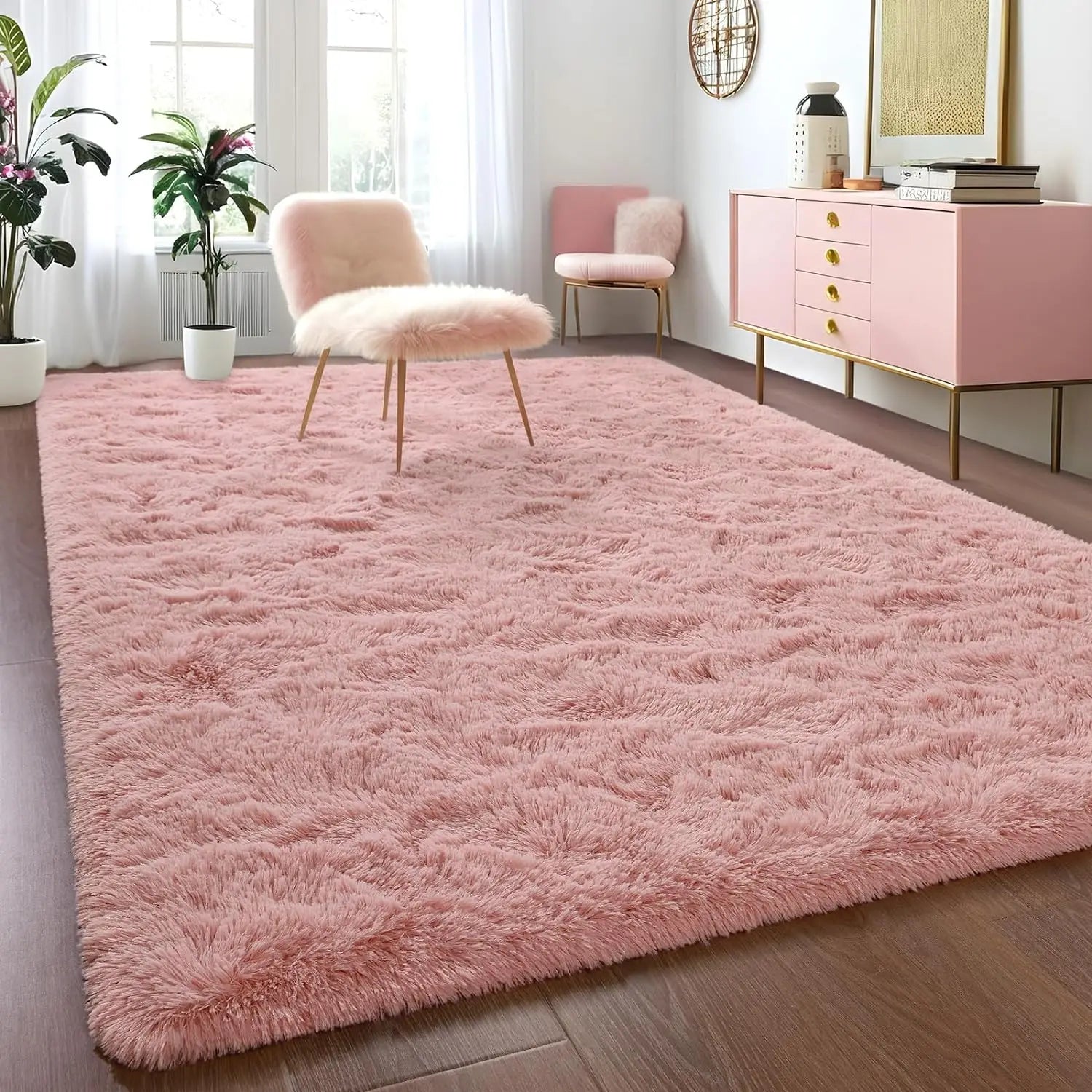 Pink shaggy rug in a room with pink chairs and a cabinet.