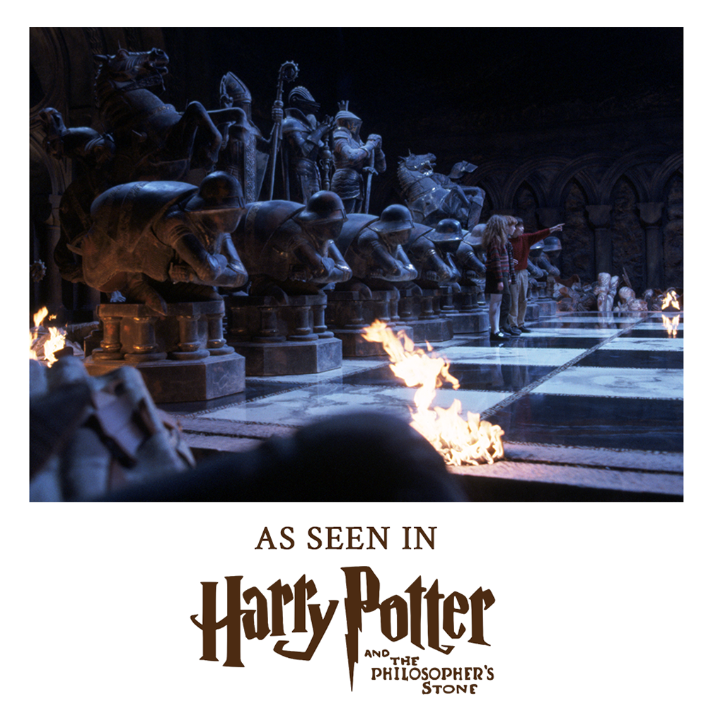 Scene from 'Harry Potter' with stone statues and flames, text indicating movie reference.