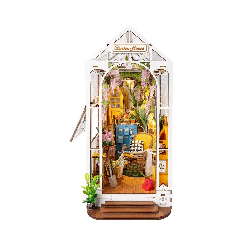 holiday garden house diy book nook kit, lit miniature house bookend that slots between books on a shelf