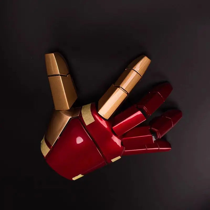 Red and gold mechanical glove on a black background