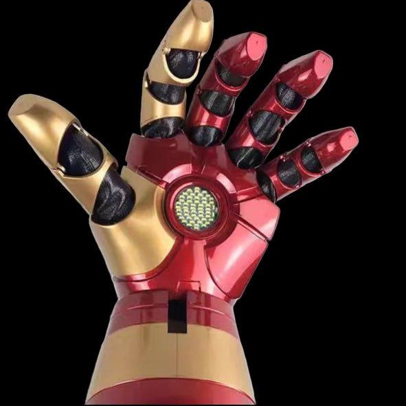 Red and gold mechanical hand with a glowing green panel on a black background